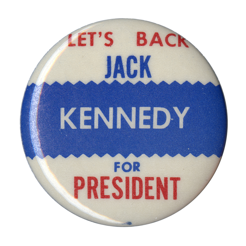 Round, white button with a blue horizontal stripe at the center. Red, blue, and white text reads "Let's Back Jack Kennedy for President". 