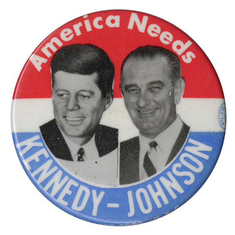 Round button with three horizontal stripes of red, white, and blue. Two grayscale portraits of John F. Kennedy and Lyndon B. Johnson are at the center. White text reads "America needs Kennedy - Johnson" and encircles the portrait. 
