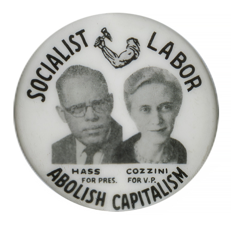 Round, white button with grayscale portraits of Eric Hass and Georgia Cozzini and a drawing of a muscular arm holding a hammer. Black text encircling the portraits reads "Socialist Labor Abolish Capitalism Hass for Pres. Cozzini for V.P."