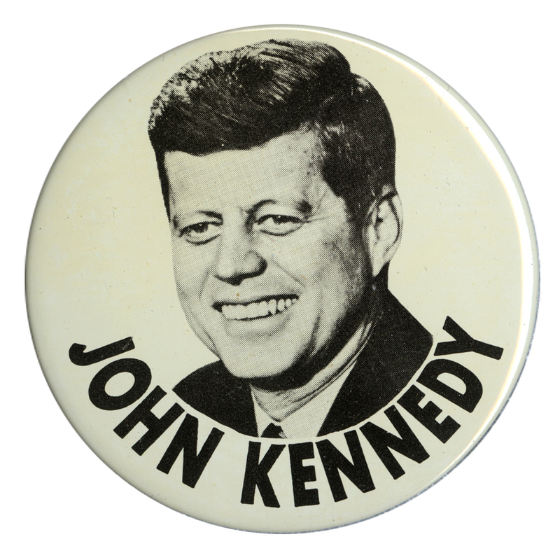 Round, white button with a large portrait of John F. Kennedy. Below the portrait is black text that reads "John Kennedy".