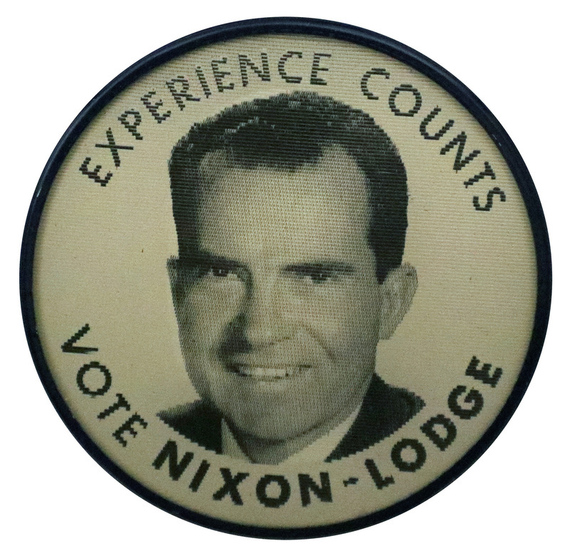 Round, black and white button with a portrait of Richard Nixon and the text "Experience Counts, Vote Nixon-Lodge." This is one angle of a holographic button.