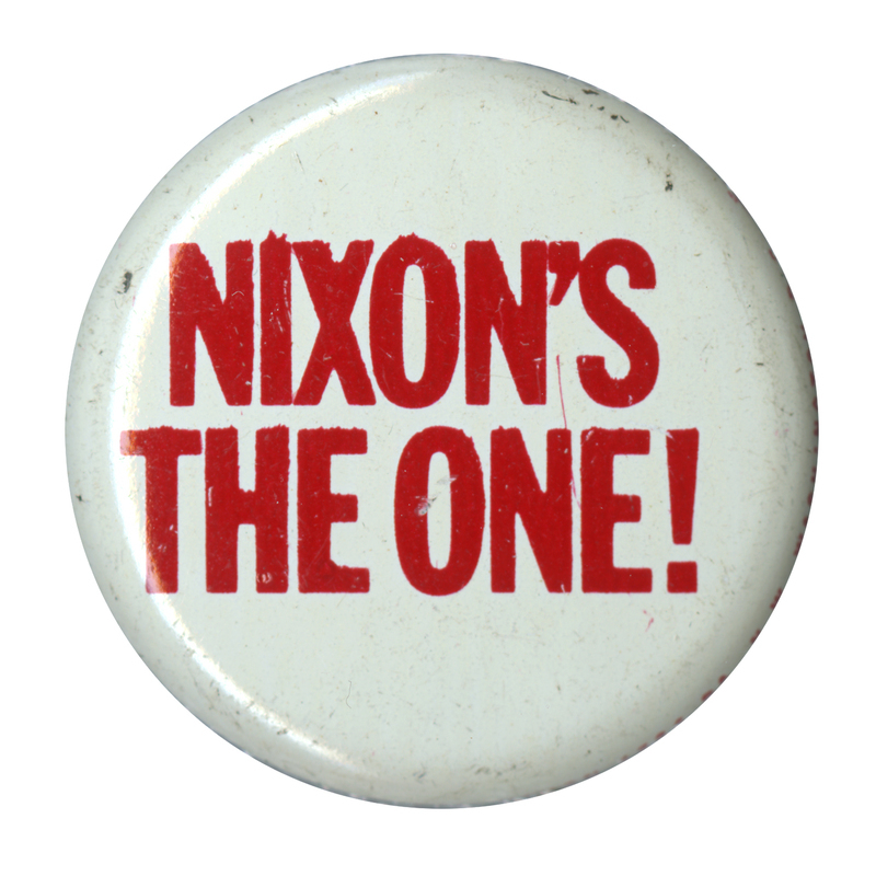 Round, white button with bold, red text reading "Nixon's the One!". 