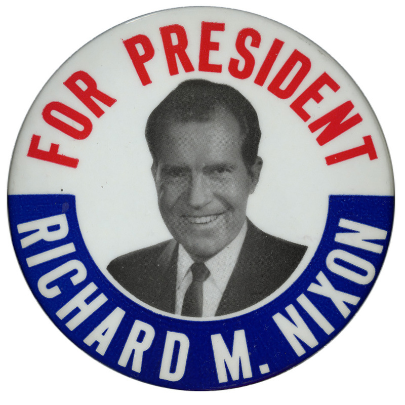 Round, white button with a blue border at the bottom, and a grayscale portrait of Richard M. Nixon. Red and white text encircling the portrait reads "For President Richard M. Nixon". 