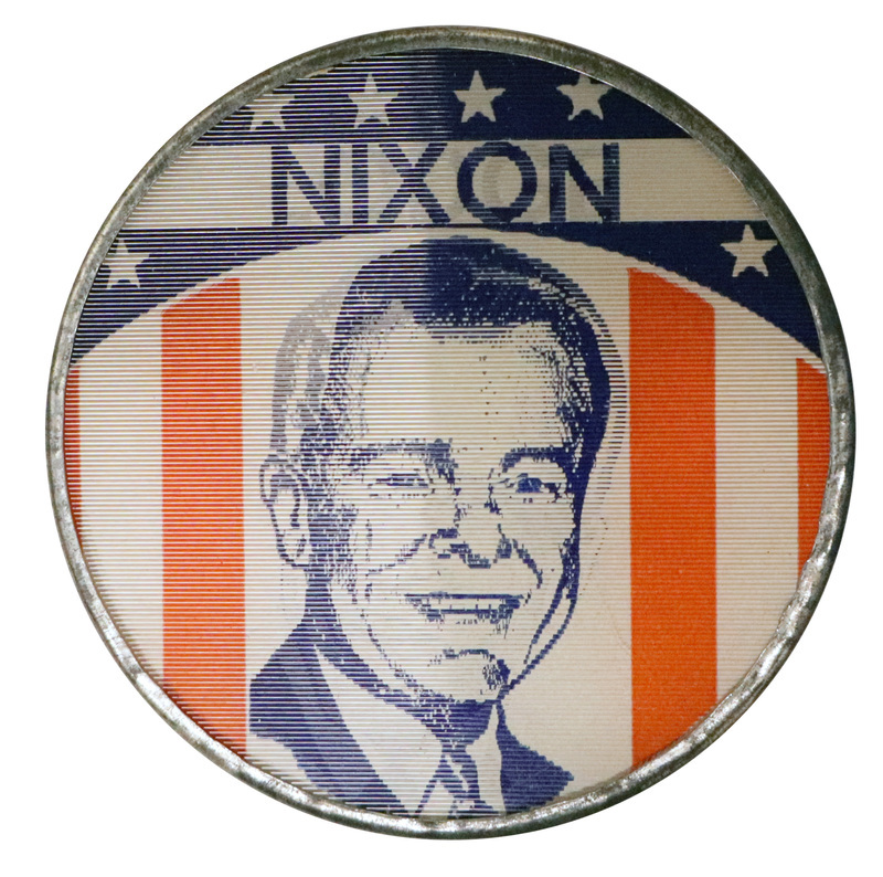 Round button with US flag decorations and a portrait with text reading "Lodge." This is one angle of a holographic button.