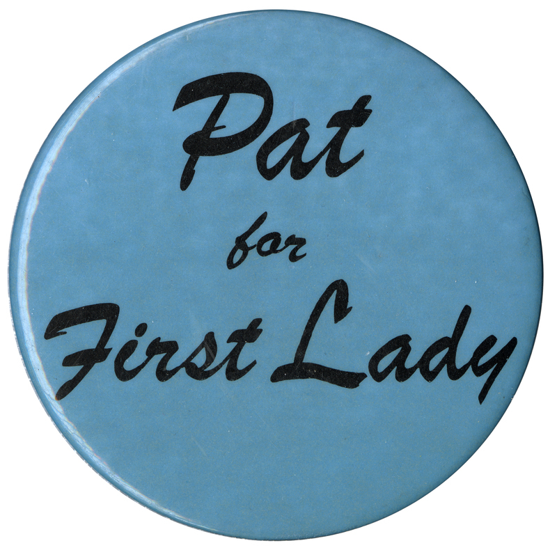 Round, light blue button with cursive text reading "Pat for First Lady". 