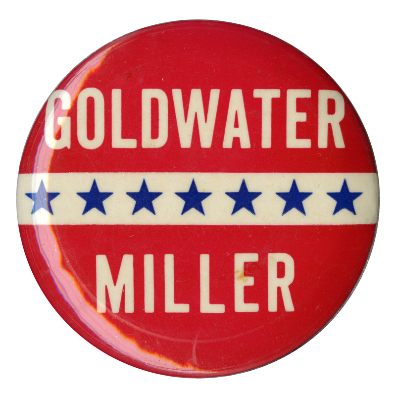 Round, red button with a white stripe across the center and decorative stars across it. White text reads "Goldwater Miller". 