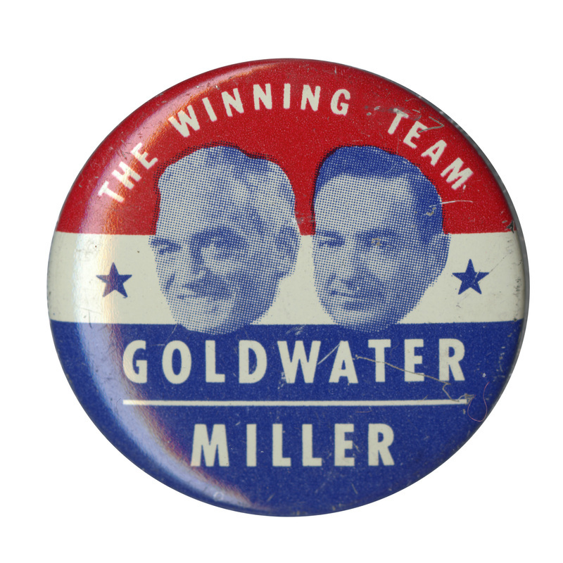 Round button with horizontal stripes of red, white, and blue, and two grayscale portraits of Barry Goldwater and William Miller. White text reads "The Winning Team Goldwater Miller" and encircles the portraits. 