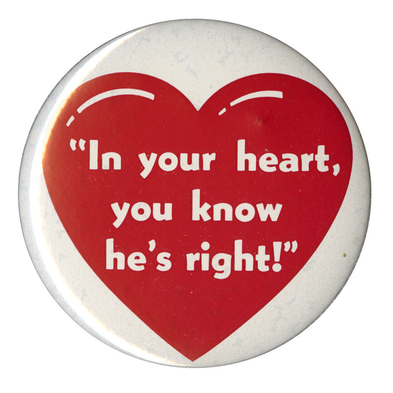 Round, white button with a red heart at the center. White text reads ""In your heart, you know he's right!"".
