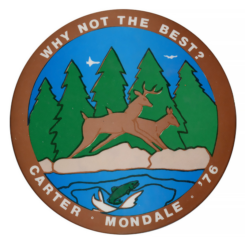 Round button with a color drawing of two deer, a fish jumping out of water, and trees. In a brown band along the edge of the button, white text reads "WHY NOT THE BEST? CARTER-MONDALE-'76"