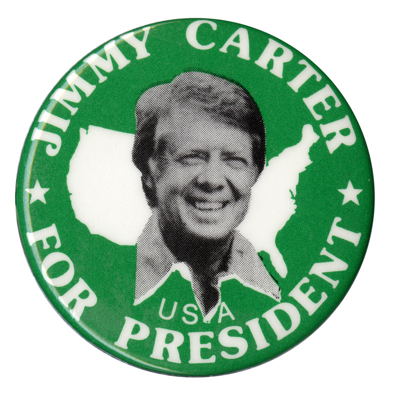 Round, green button with a black and white photograph of Jimmy Carter against a white outline of the United States. White text reads "JIMMY CARTER FOR PRESIDENT USA"
