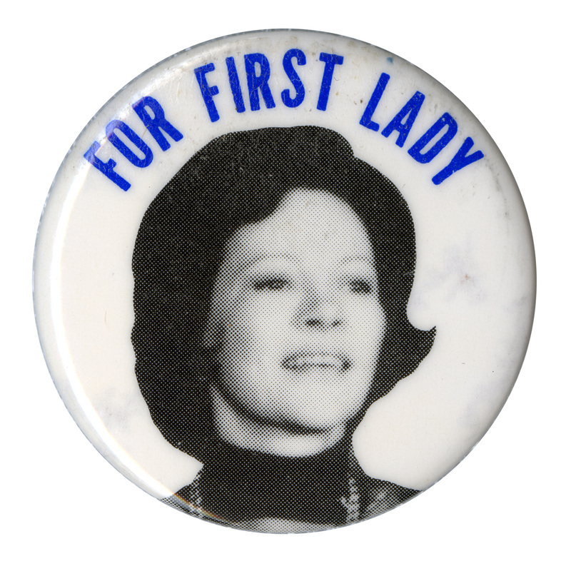 Round, white button with a black and white photograph of Rosalynn Carter. Blue text reads "FOR FIRST LADY"