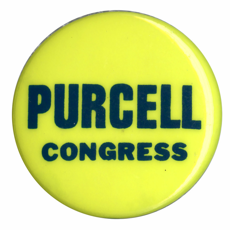 Round, yellow button with black text reading "PURCELL CONGRESS"