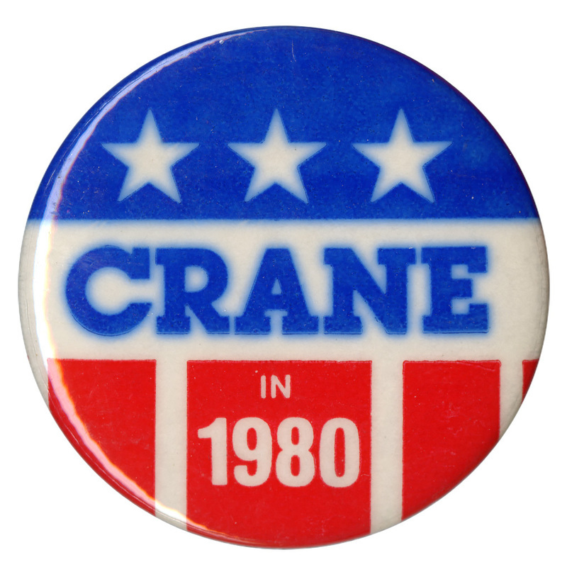 Round button with red, white, and blue stars and stripes decoration. Blue and white text reads "CRANE IN 1980"