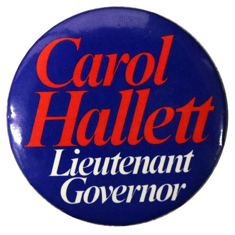 Round, blue button with red and white text reading "Carol Hallett Lieutenant Governor"