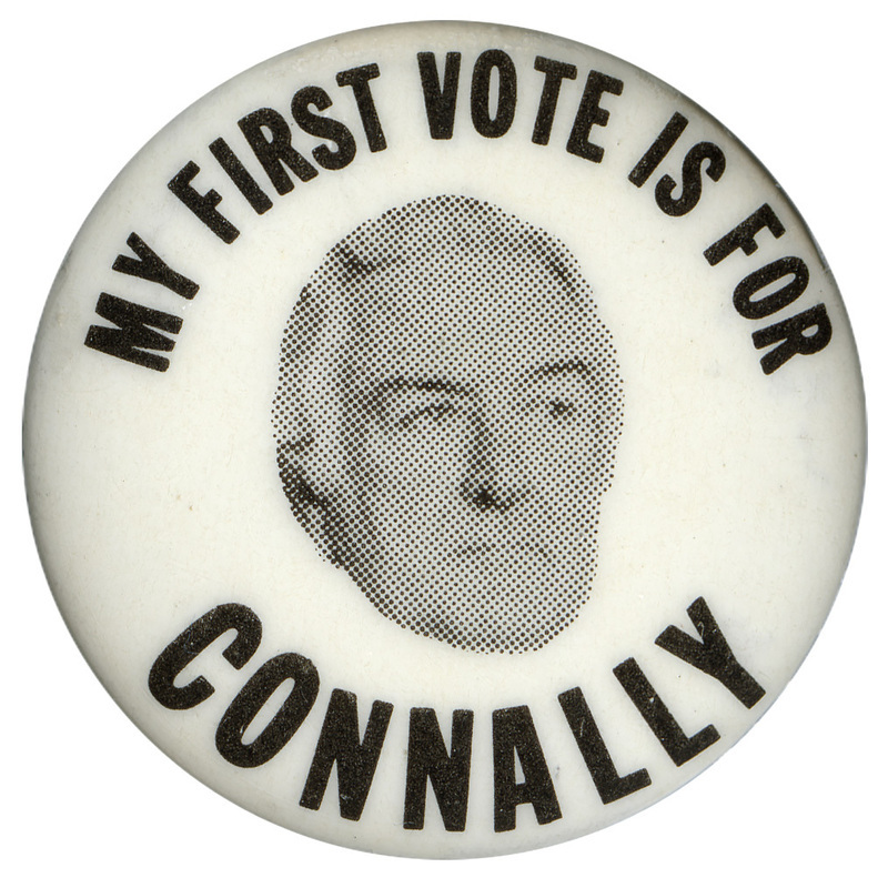 Round, white button with a black and white photograph of John Connally. Black text reads "MY FIRST VOTE IS FOR CONNALLY"