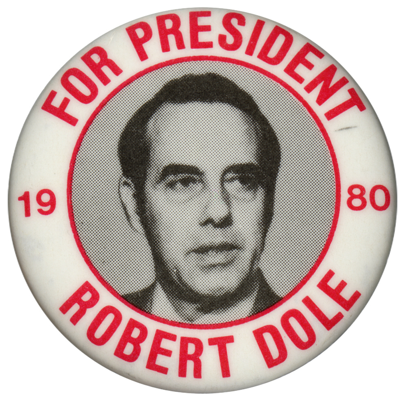 Round, white button with a black and white photograph of Bob Dole within a red circle in the middle Red text around the edge of the button reads "FOR PRESIDENT 1980 ROBERT DOLE"