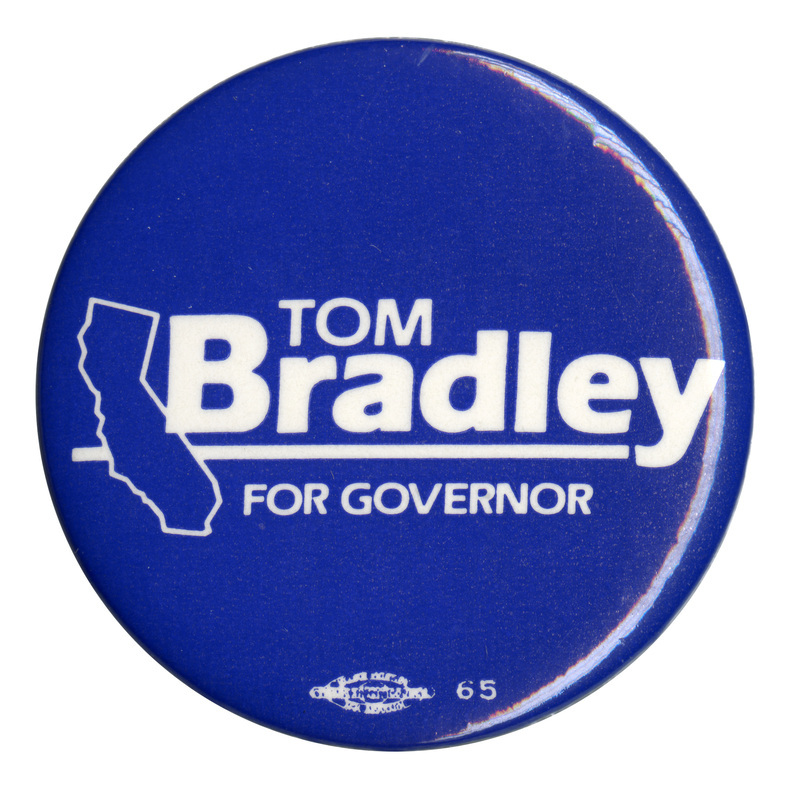 Round, blue button with a white outline of the state of California and white text reading "TOM Bradley FOR GOVERNOR"