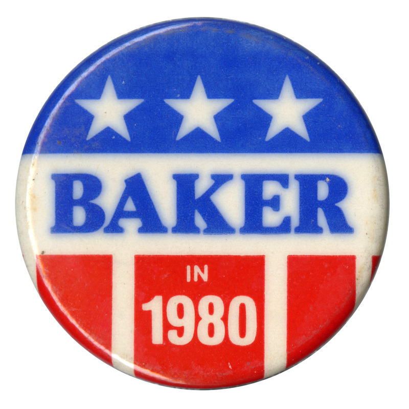 Round button with red, white, and blue stars and stripes decoration. Blue and white text reads "BAKER IN 1980"