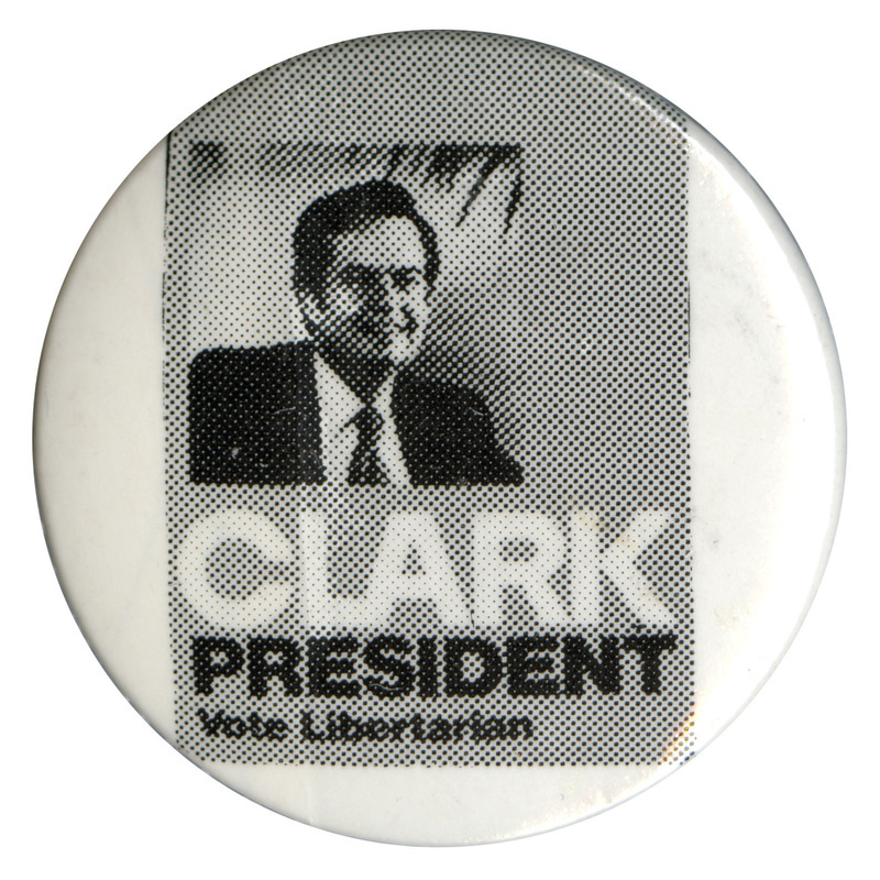 Round, white button with a square gray section containing a black and white photograph of Ed Clark. White and black text reads "CLARK PRESIDENT Vote Libertarian"