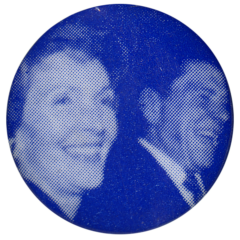 Round, blue button with a blurry photograph of Nancy Reagan and Ronald Reagan.