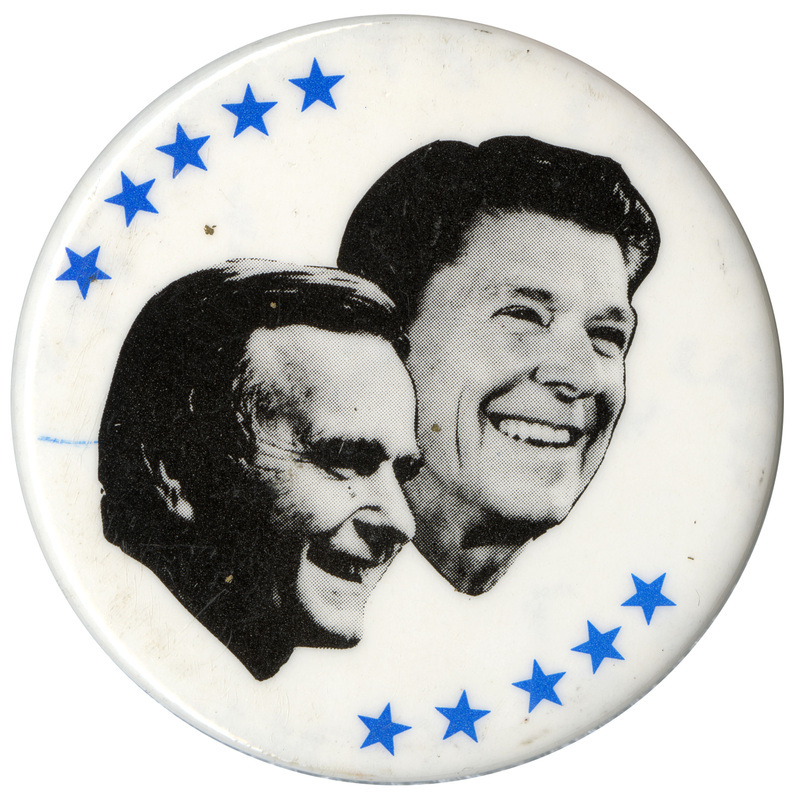 Round, white button with black and white photographs of George H. W. Bush and Ronald Reagan surrounded by blue stars.