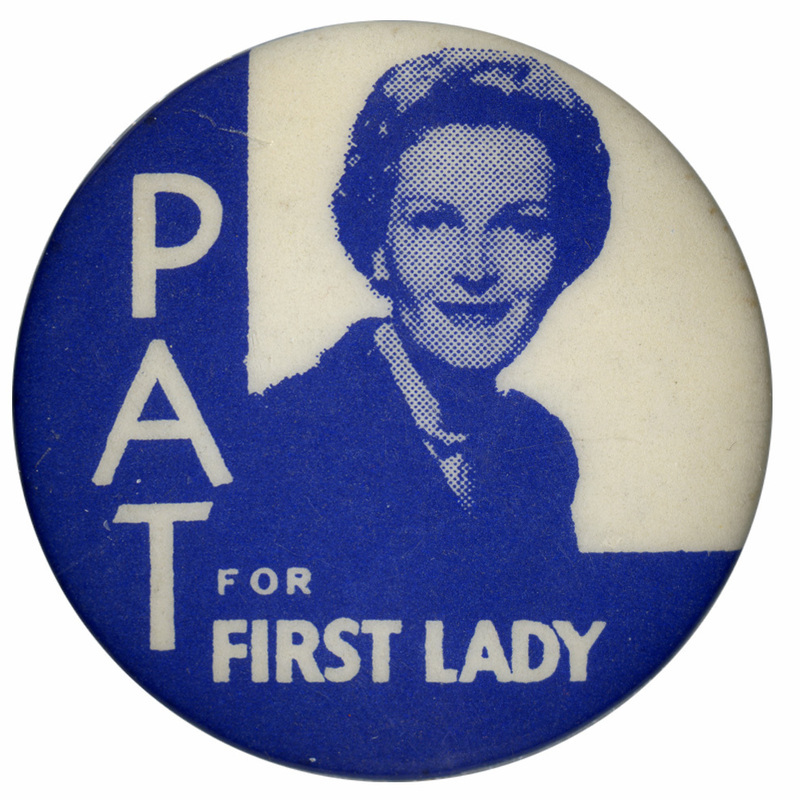 Round, white and blue button with a portrait of Pat Nixon and white text reading "Pat for First Lady."