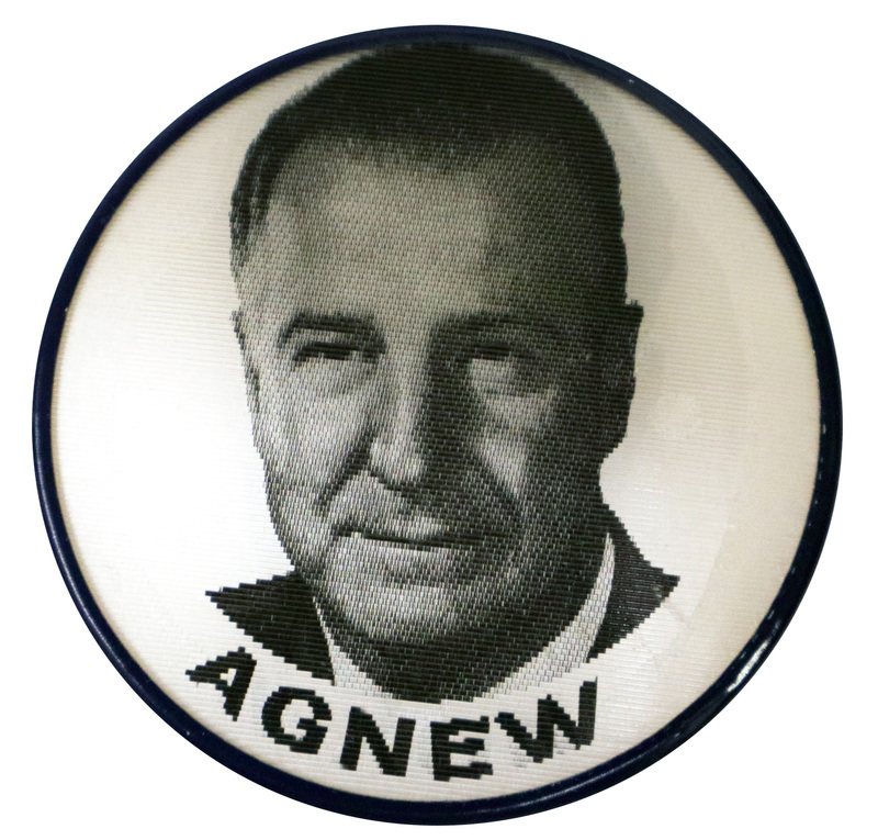Round, white button with a portrait of Spiro Agnew and black text reading "Agnew." This is one angle of a holographic button.