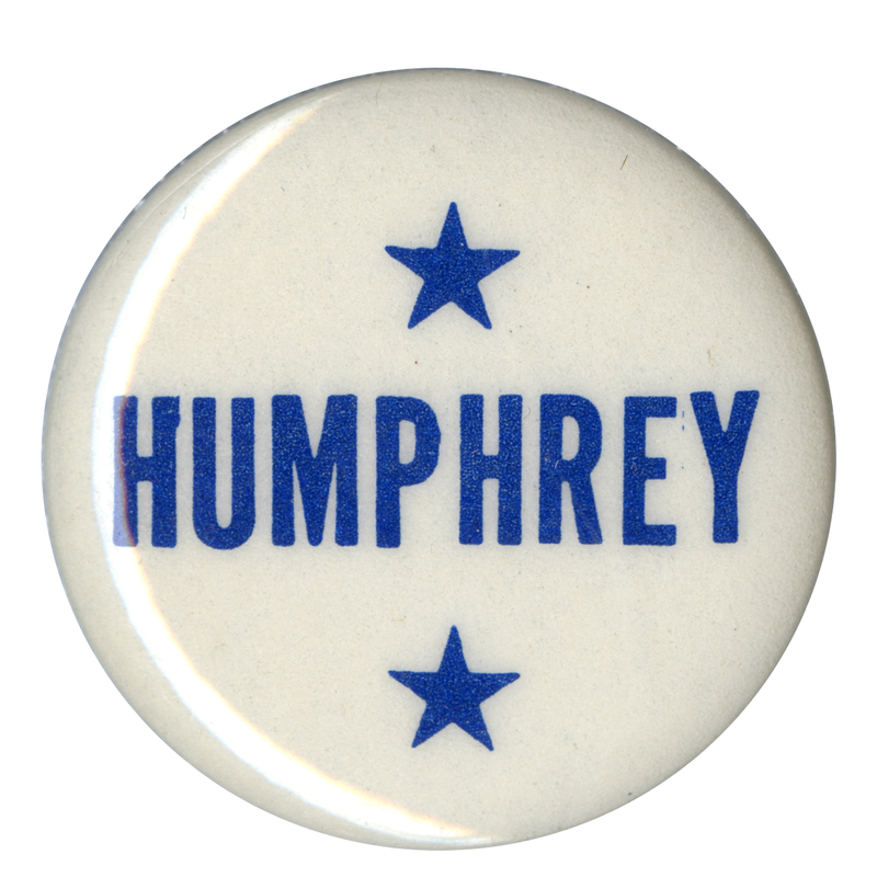 Round, white button with blue stars and blue text reading "Humphrey."