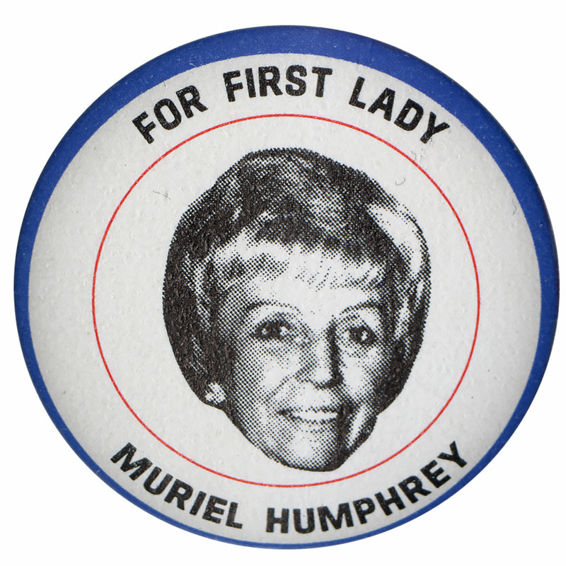 Round, white button with a black and white portrait of Muriel Humphrey surrounded by red and blue circular lines. Black text reads "For First Lady, Muriel Humphrey."
