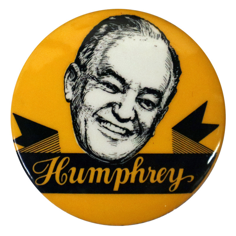 Round, yellow button with a black and white drawing of Hubert Humphrey and a ribbon reading "Humphrey" in cursive script.