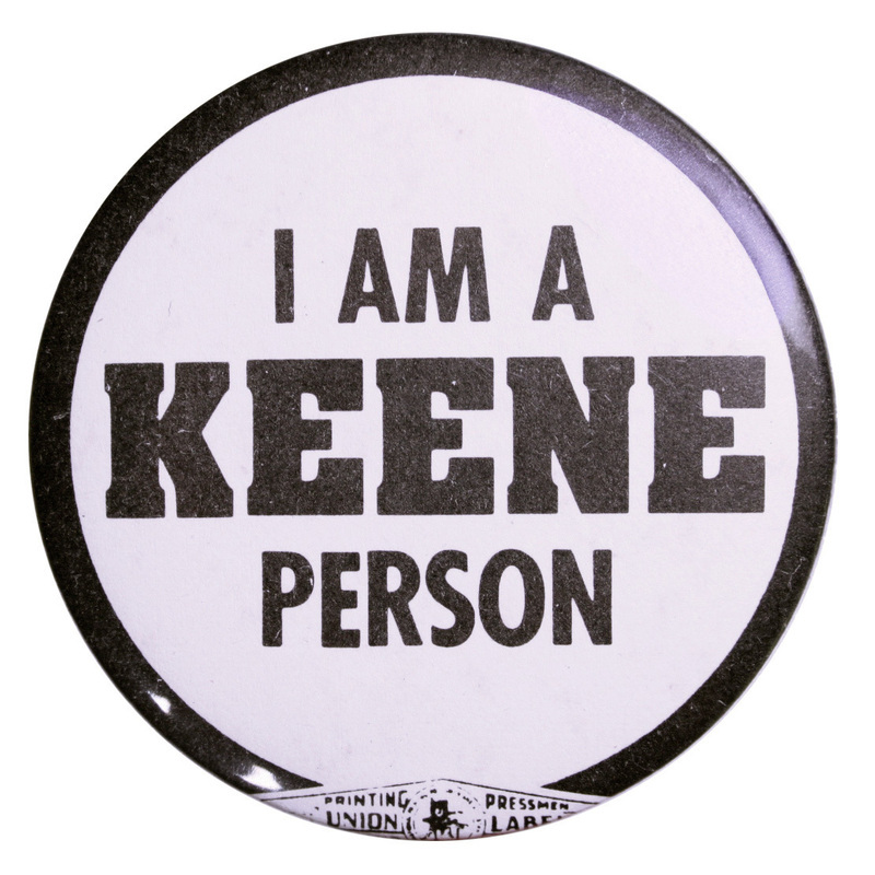 Round, black and white button with black text reading "I am a Keene person."