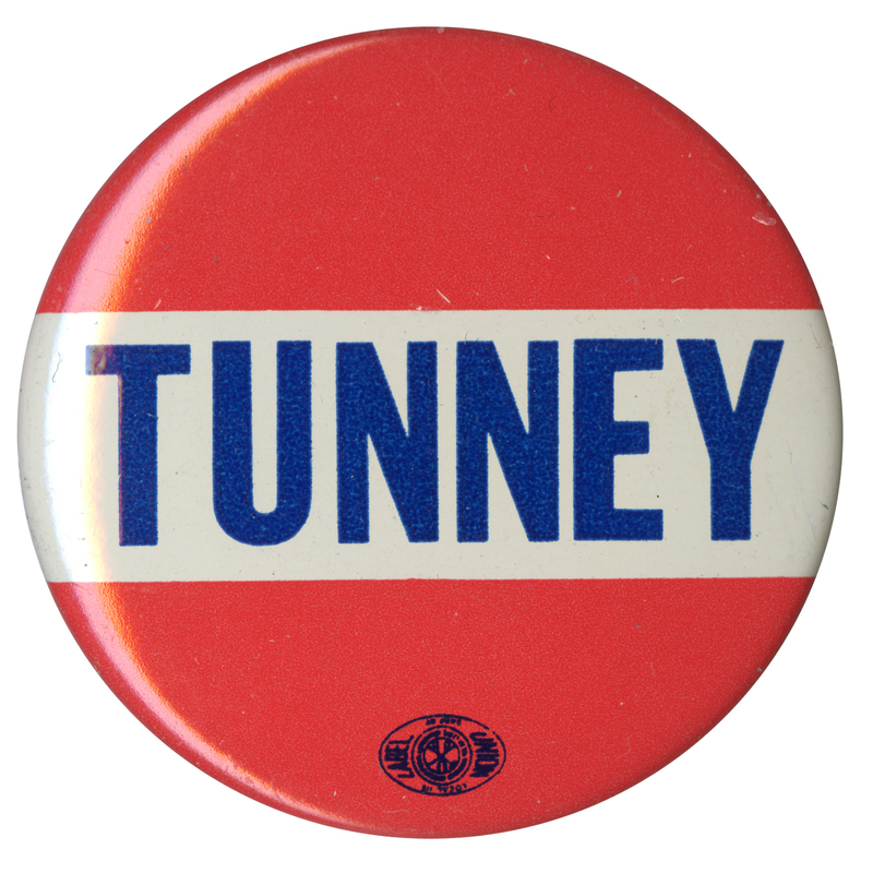 Round, red and white button with blue text reading "Tunney."