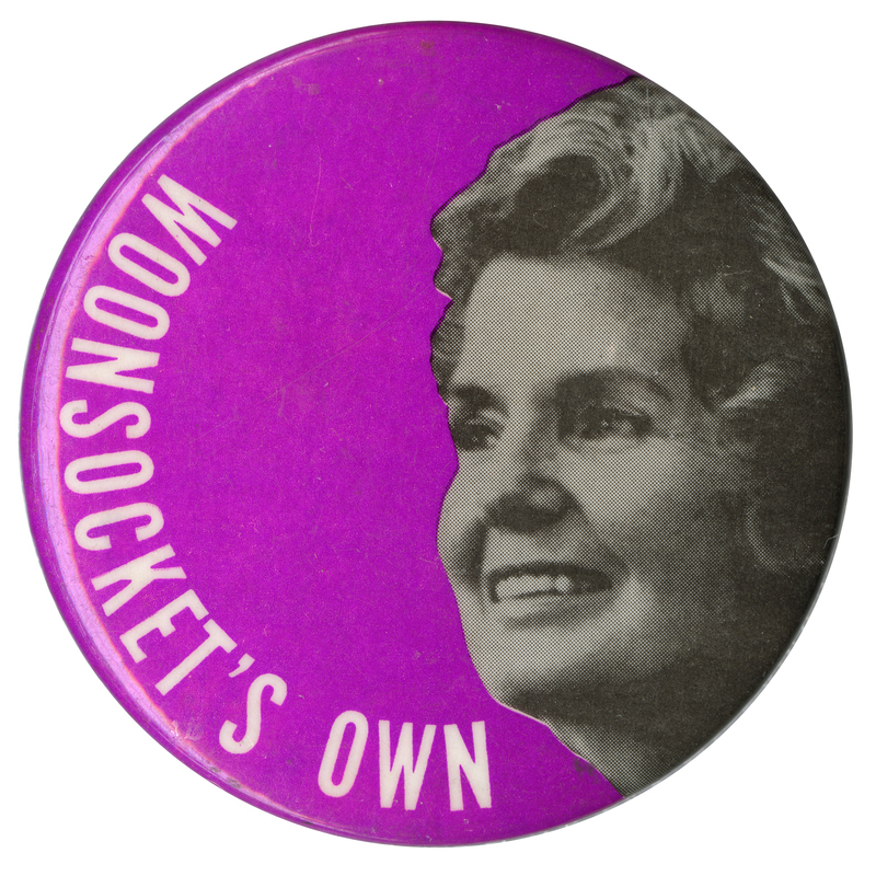 Round, purple button with a black and white portrait of Eleanor McGovern and white text reading "Woonsocket's Own."