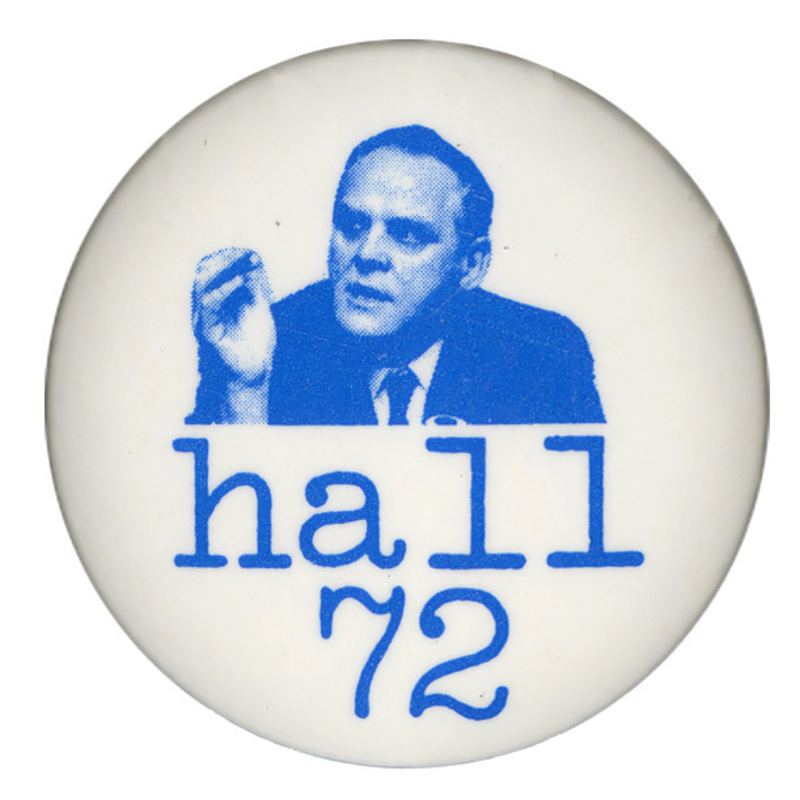 Round, white button with a blue portrait of Gus Hall. Blue text reads "hall 72."