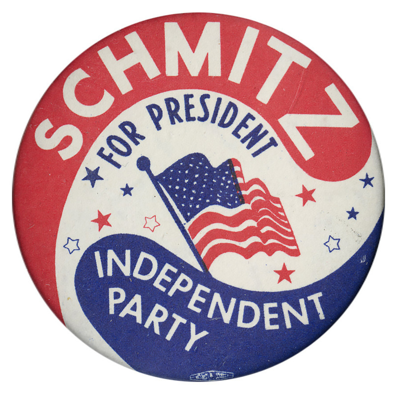 Round, red, white, and blue button with a drawing of the US flag and several stars. White and blue text reads "SCHMITZ FOR PRESIDENT INDEPENDENT PARTY"