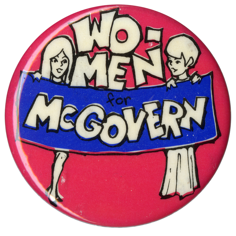 Round, red button with a line drawing of two people holding a blue banner. White, blocky text reads "WO-MEN for McGOVERN"
