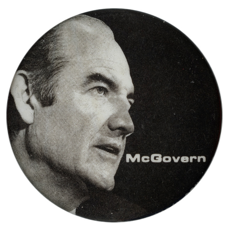Round, black button with a black and white button of George McGovern and white text reading "McGovern"