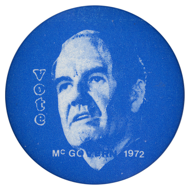 Round, blue button with a portrait of George McGovern and white text reading "Vote McGOVERN 1972"