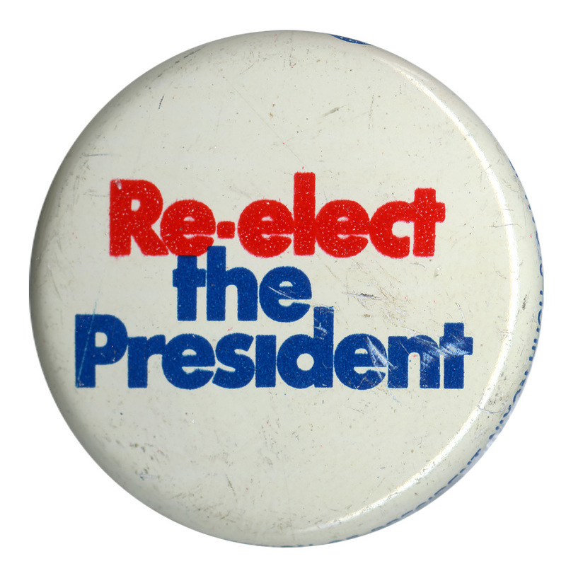 Round, white button with red and blue text reading "Re-elect the President"