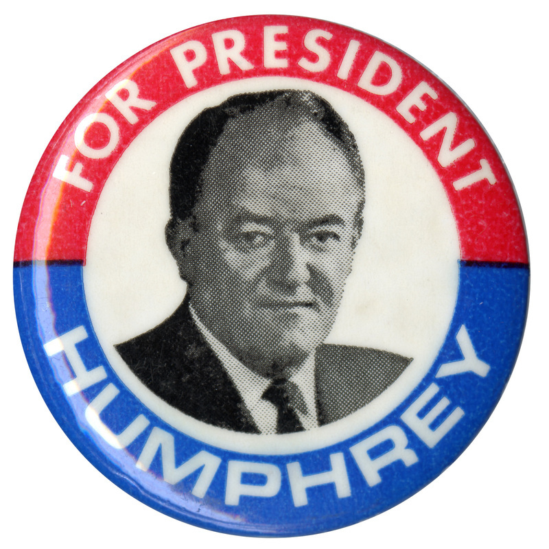 Round, red, white, and blue button with a black and white portrait of Hubert Humphrey and white text reading "FOR PRESIDENT HUMPHREY"