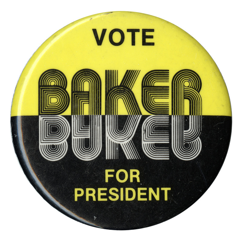 Round button with a yellow upper half and black lower half. Black, white and yellow text reads "VOTE BAKER FOR PRESIDENT". "BAKER" is mirrored in the middle of the button.