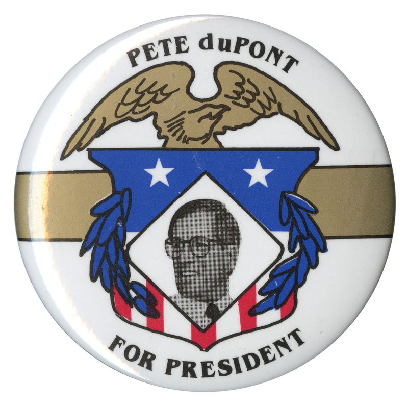 Round, white button with a black and white photograph of Pete du Pont surrounded by red, gold, white, and blue eagle, shield, and leaf decorations. Black text reads "PETE duPONT FOR PRESIDENT"