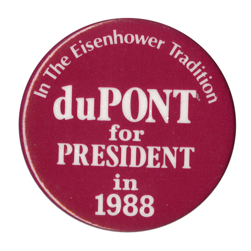 Round, red button with white text reading "In The Eisenhower Tradition duPONT for PRESIDENT in 1988"