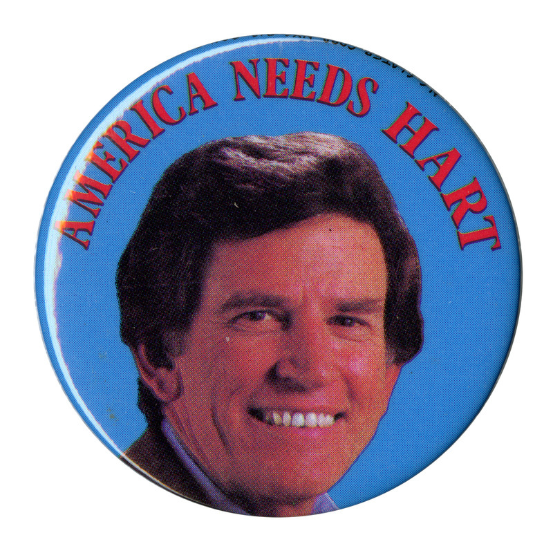 Round, blue button with a color photograph of Gary Hart and red text reading "AMERICA NEEDS HART"