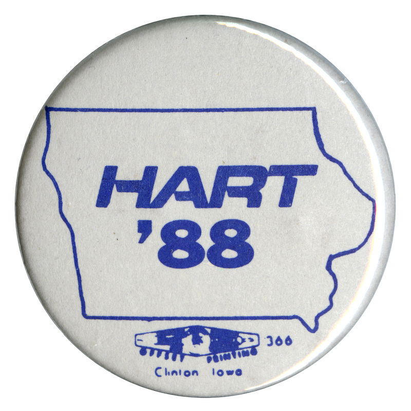 Round, white button with a blue outline of the state of Iowa and blue text reading "HART '88"