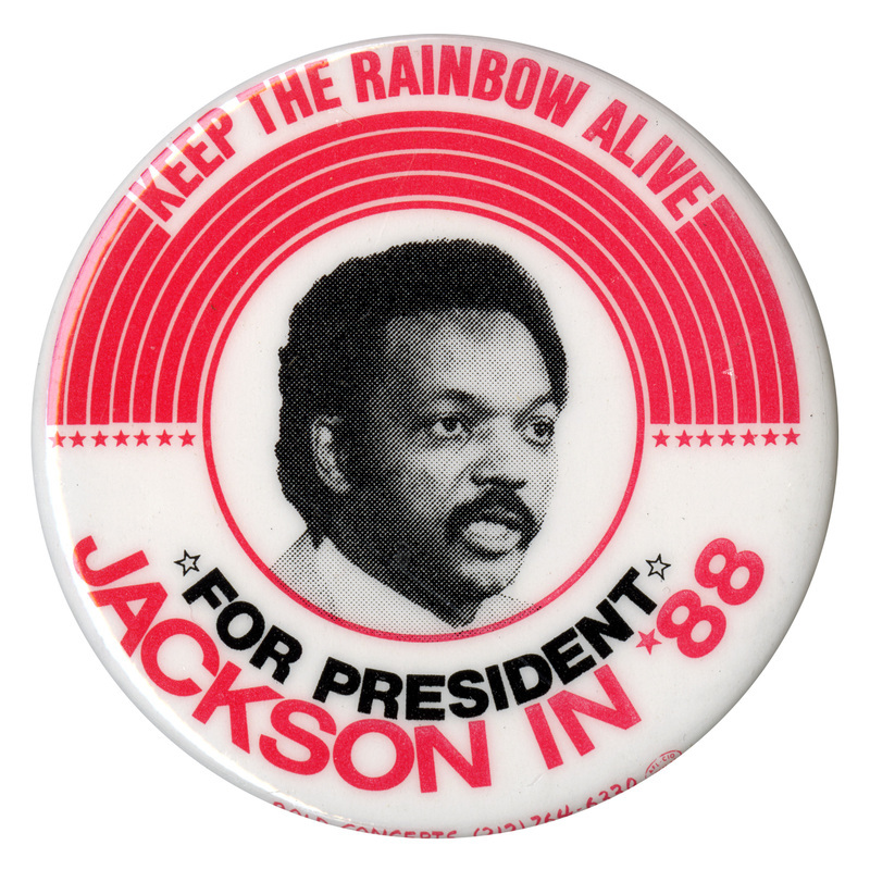 Round, white button with red stars and stripes surrounding a black and white photograph of Jesse Jackson. Red and black text reads "KEEP THE RAINBOW ALIVE FOR PRESIDENT JACKSON IN '88"