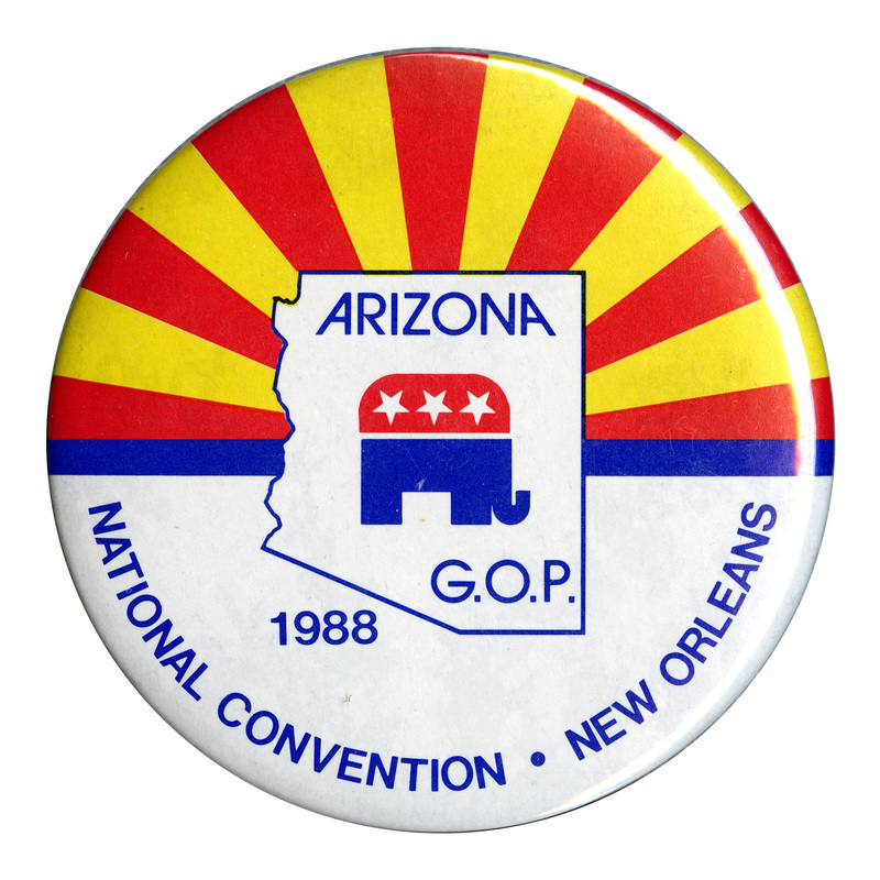 Round button with red and yellow stripes on the upper half and white on the lower half. In the center is the red, white, and blue GOP elephant symbol within an outline of the state of Arizona. Blue text reads "ARIZONA G.O.P. 1988 NATIONAL CONVENTION NEW ORLEANS"