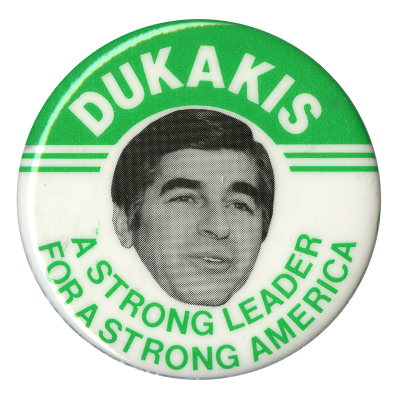 Round, green and white button with a black and white photograph of Michael Dukakis. White and green text reads "DUKAKIS A STRONG LEADER FOR A STRONG AMERICA"