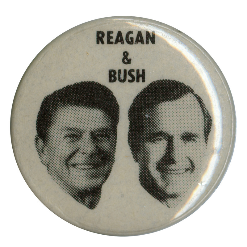 Round, white button with black and white photographs of Ronald Reagan and George H. W. Bush. Black text reads "REAGAN & BUSH"