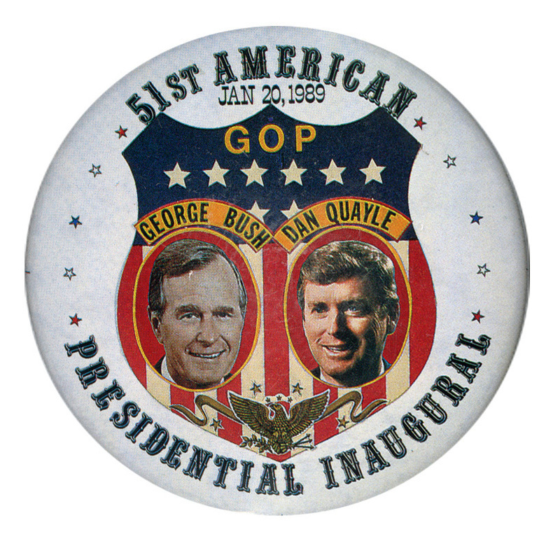 Round, white button with an elaborate red, white, blue, and gold shield decoration containing color photographs of George H. W. Bush and Dan Quayle, each with his name above his photograph. Black text reads "51st AMERICAN PRESIDENTIAL INAUGURAL"